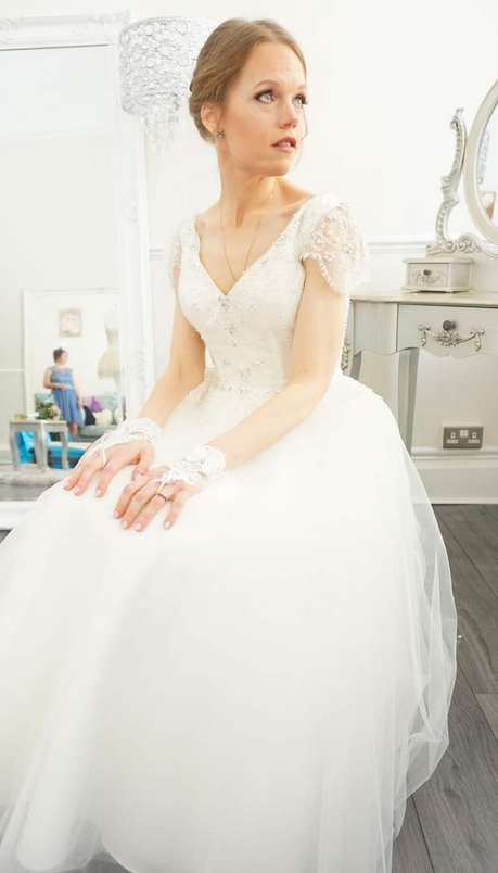 Amy wearing vintage inspired short wedding gown. Tulle and crystal covered tea length wedding dress.