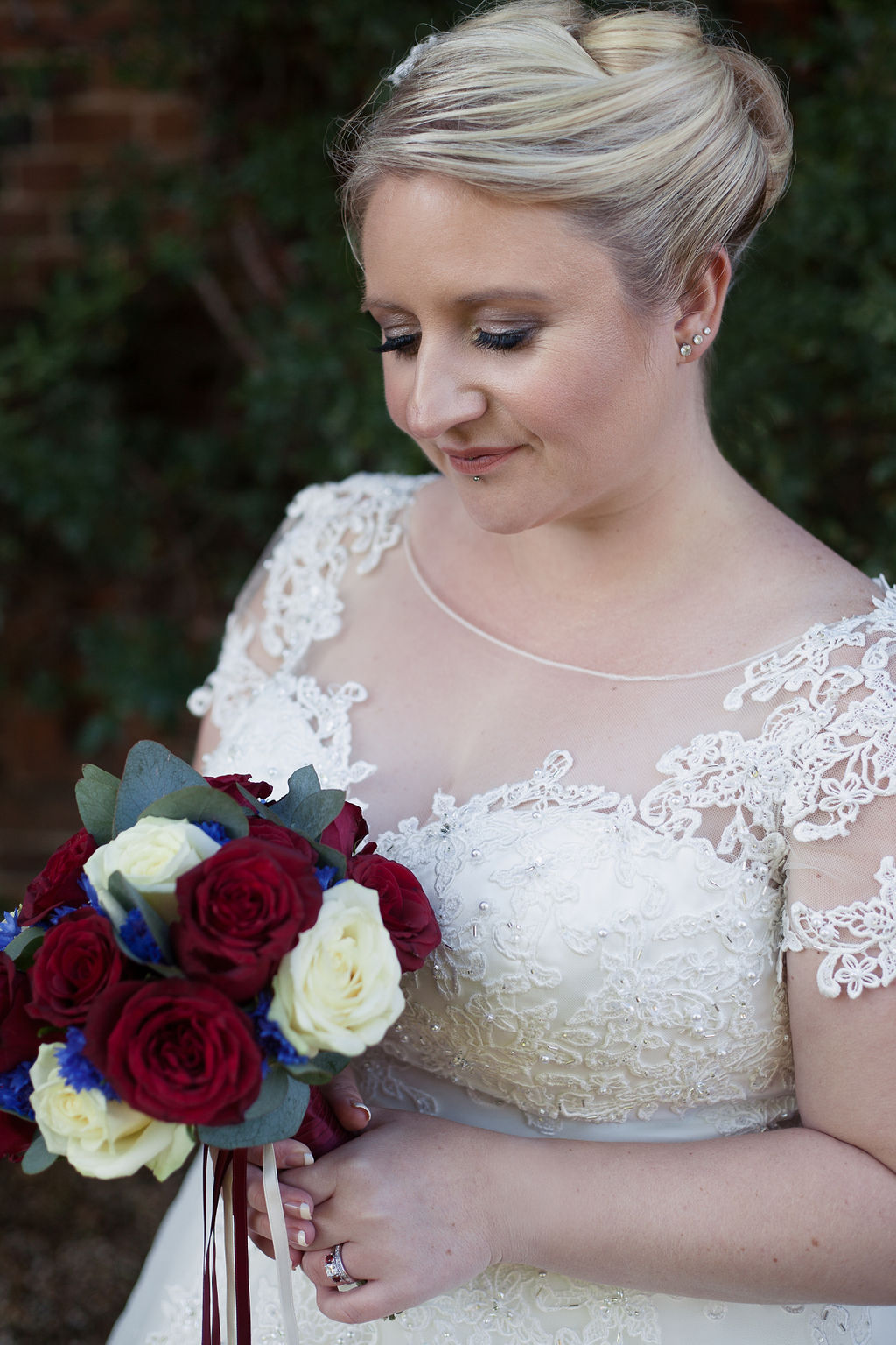 Steph and Harrys wedding with cutting edge brides. Bride with claret flowers