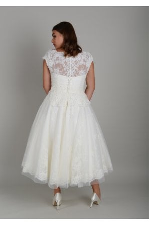 DELORES is a elegant calf length wedding dress with lace and tulle skirt, with a cap sleeve 